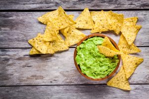homemade guacamole with corn chips top view nachos