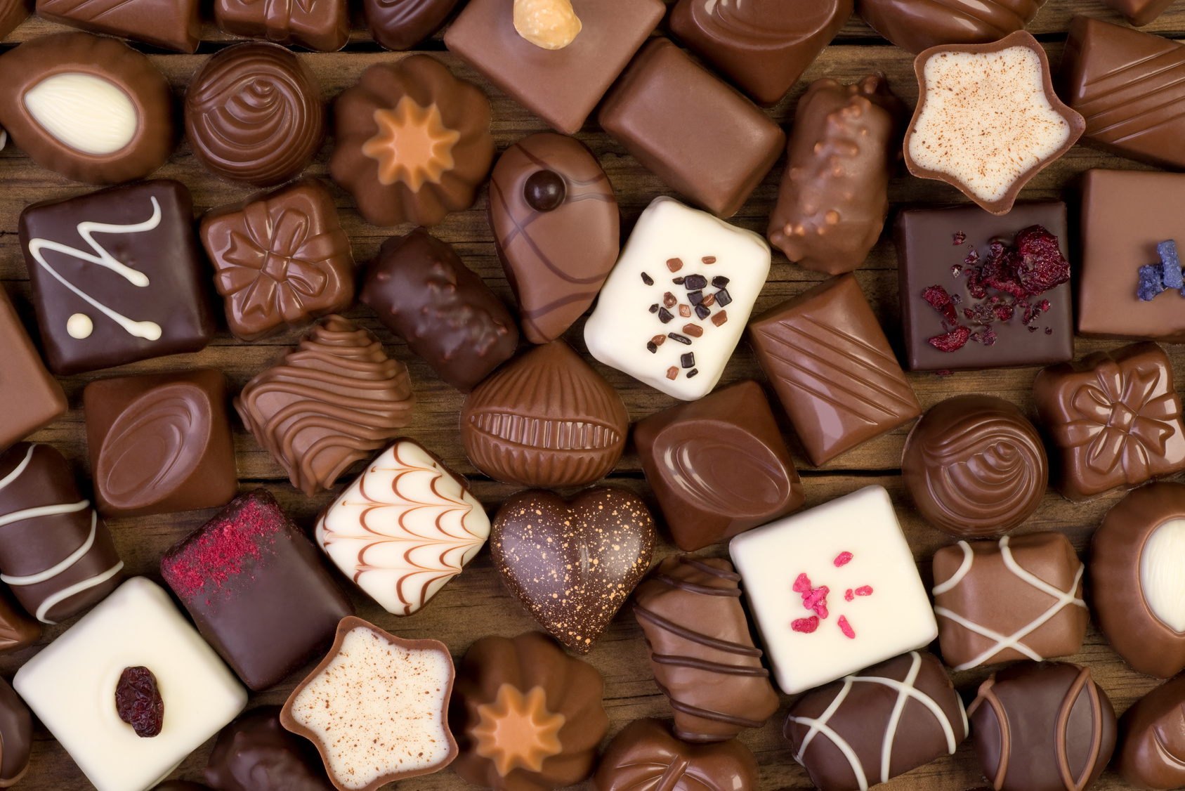 Various chocolates on wooden background