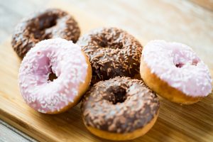close up of glazed donuts pile on table sweet baked baking doughnut
