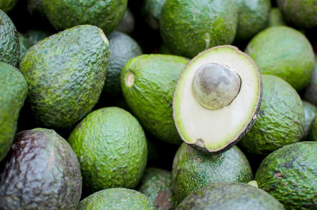 Avocado background. Fresh green avocado on a market stail.