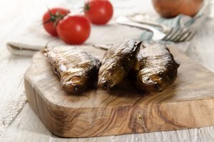smoked vendace on wooden board fish