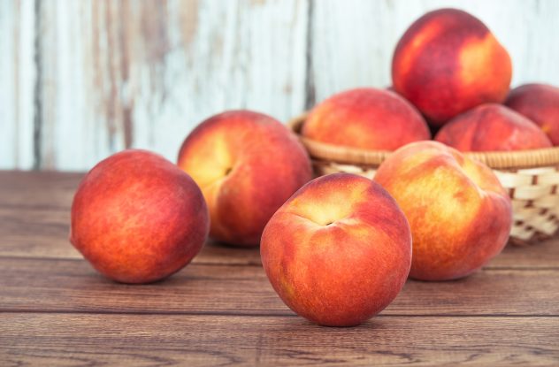 Closeup of peach fruits on wooden table