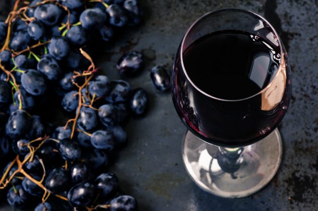 Wineglass of red wine with grapes