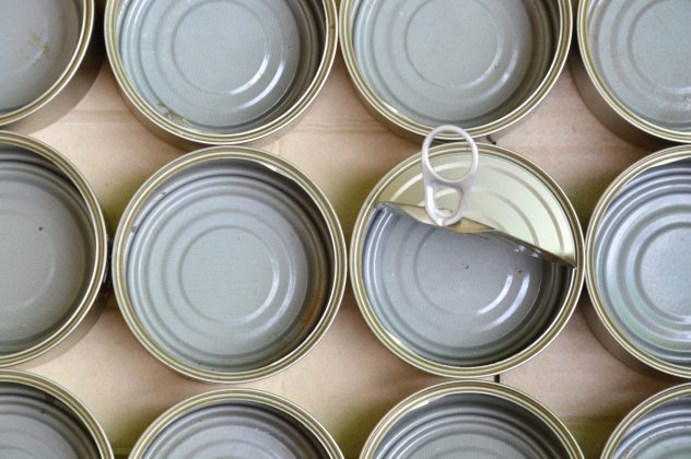 empty tin can food in brown paper box