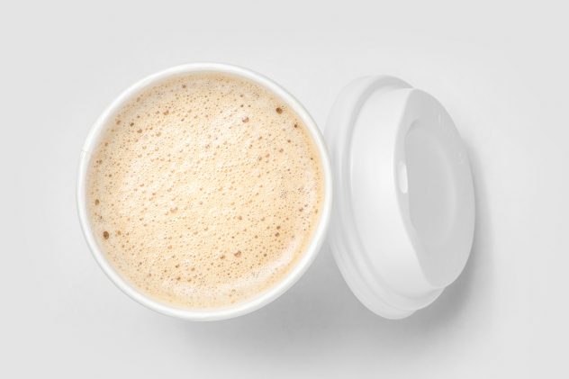 top view of paper cup mix latte coffee foam, white background coffee