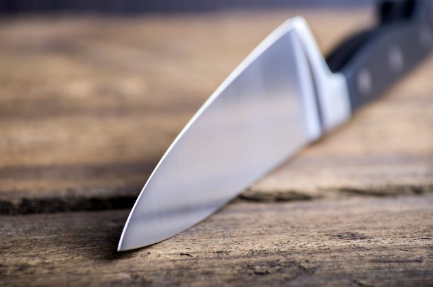 Knife on rustic kitchen table with copy space