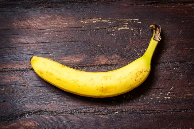 Banana on dark ol wooden table