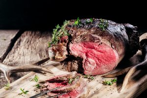 Sliced Venison Roast Seasoned with Fresh Herbs beef