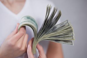 Money in female hands cost pay