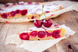 slice of cherry pie on a wooden background