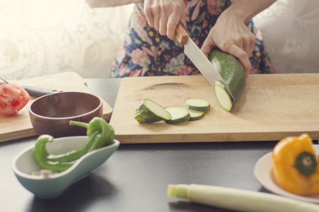 woman cooking vegetables cut chop