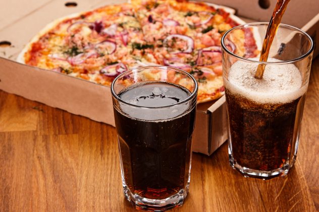 Glass of coke cola and pizza