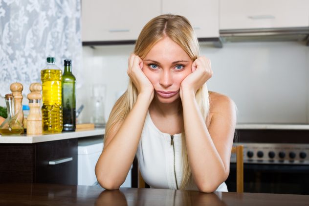 Sad woman kitchen cooking