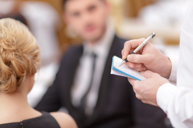 Attractive couple visiting luxury restaurant waitress waiter order