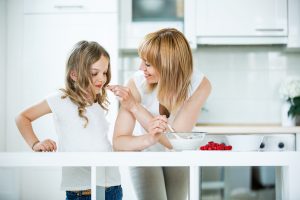 mother daughter kid child kitchen cooking berries bowl breakfast