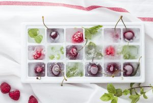 Frozen fruit and spices herbs ice cubes