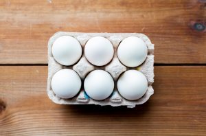 close up of white eggs in egg box or carton