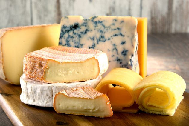 Different sorts of cheese on kitchen table