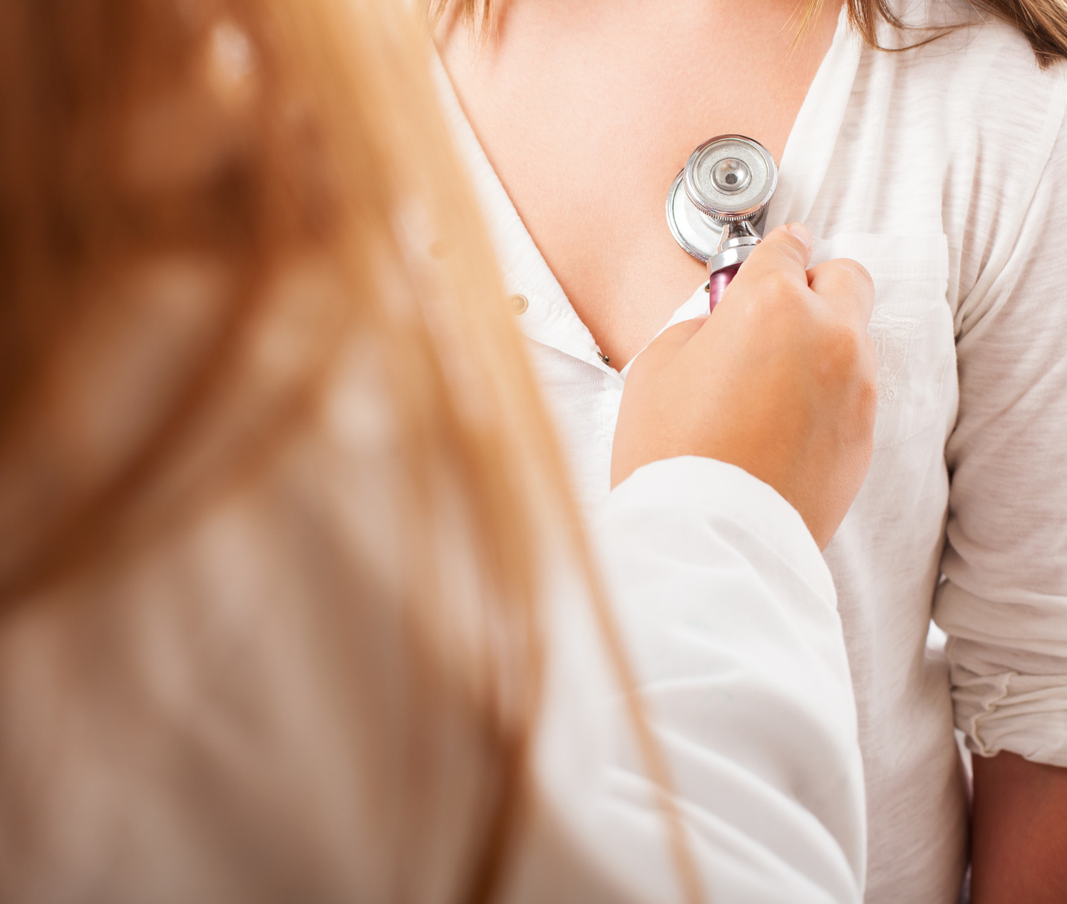 a doctor checking the heart rate of a girl