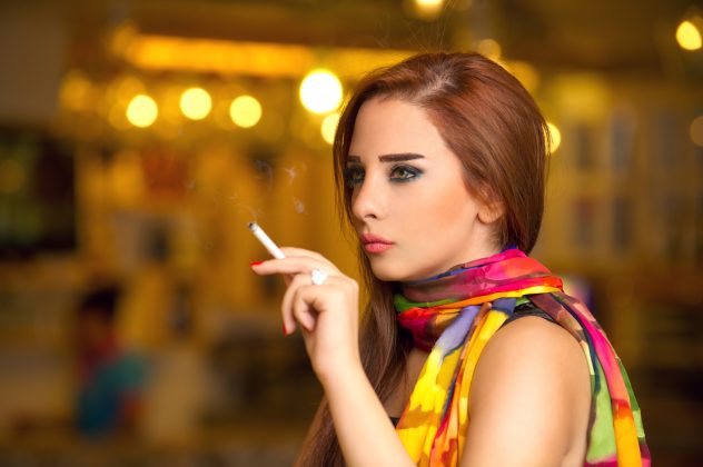 Beautiful model smoking  in a cafe