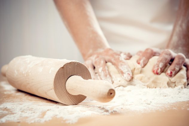 Woman kneading dough, close-up photo baking