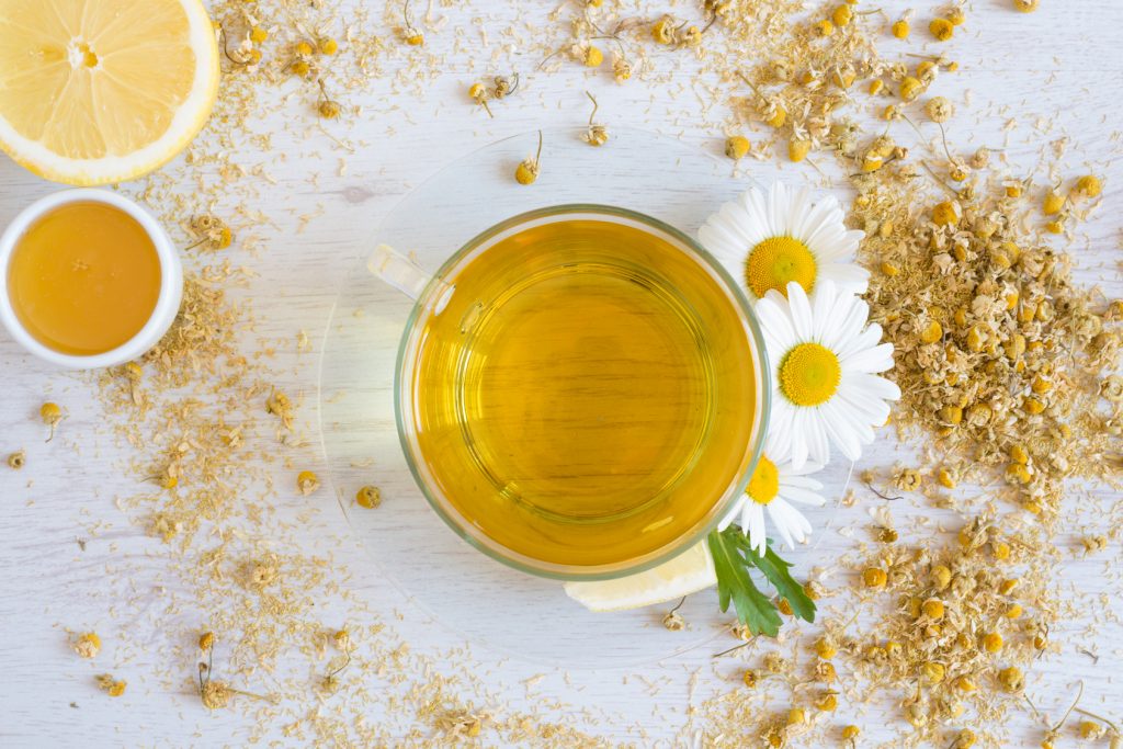 chamomile tea with lemon and honey on the wooden board