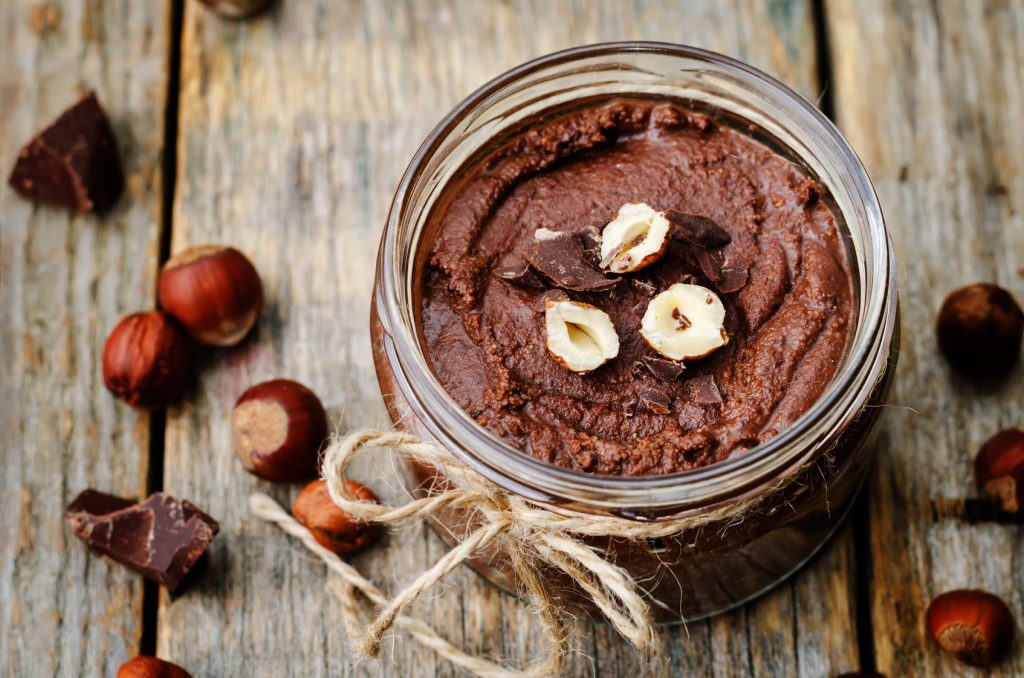 toasted hazelnut chocolate butter on a dark wood background. toning. selective focus