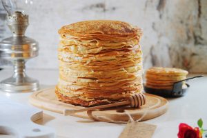 Stack pancakes on Shrove Tuesday on a light background