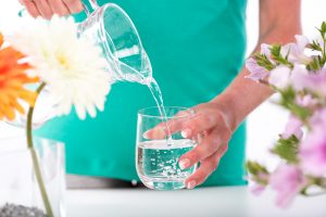 Woman pouring water into a glass