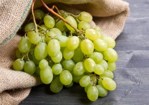 bunch green grapes on wooden background