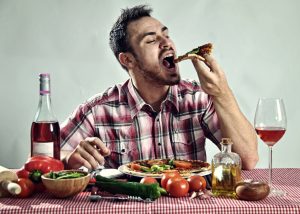 Crazy hungry man eating pizza