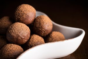 Chocolate truffles in bowl on dark wooden table sweet treat baking baked