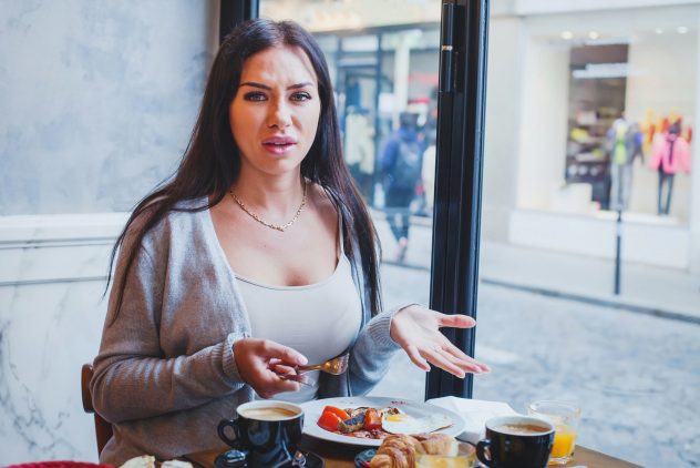 unhappy customer in restaurant, angry woman complaining about food and service in cafe