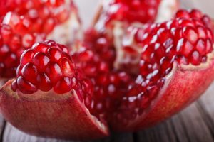 Ripe pomegranate fruit on wooden background.selective focus. closeup