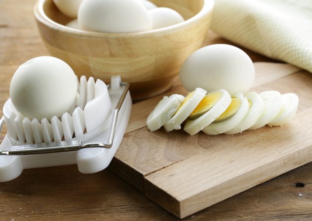 sliced boiled egg for salad on the board cooked egg