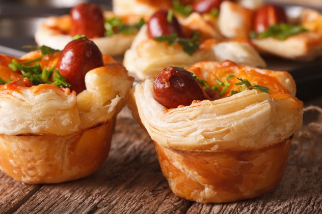 Beautiful snack muffins with sausage, cheese and onion macro. horizontal morning breakfast baking baked sausage oven