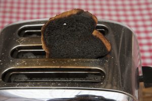Slice of burnt toast in a toaster machine