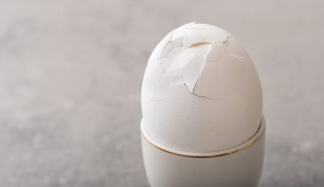 Breakfast egg with cracked eggshell