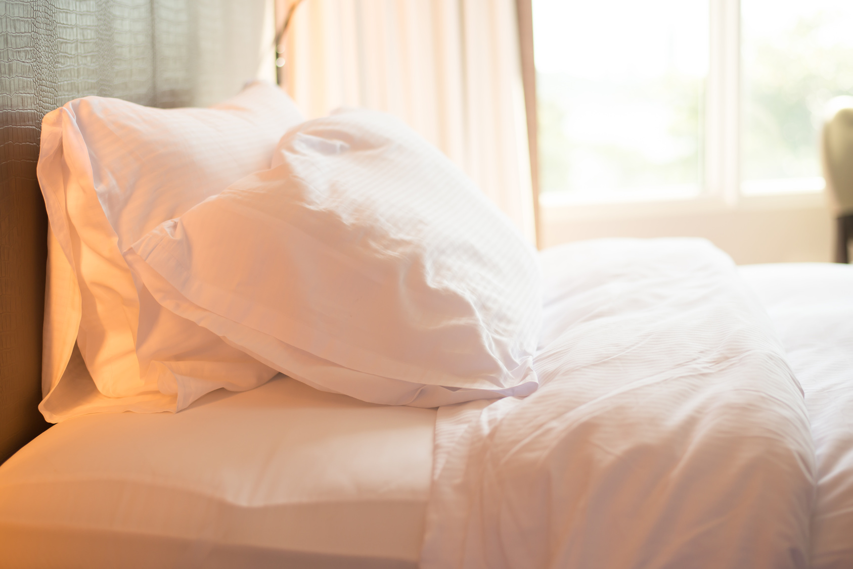 Bed and white pillow in bedroom