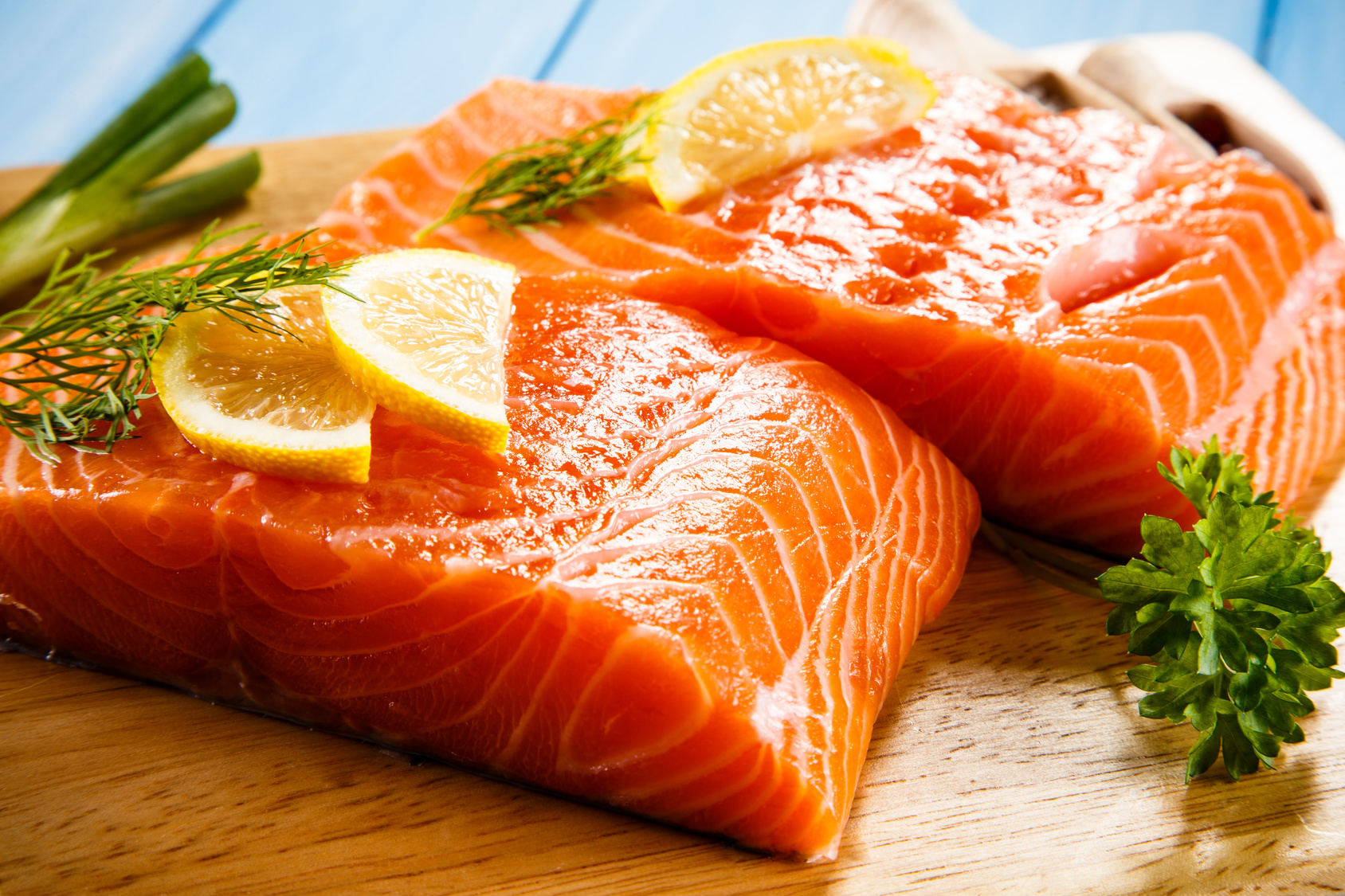 Fresh raw salmon fillets on cutting board