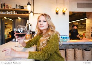 Woman drinking wine in restaurant