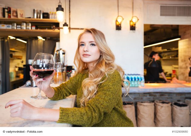 Woman drinking wine in restaurant