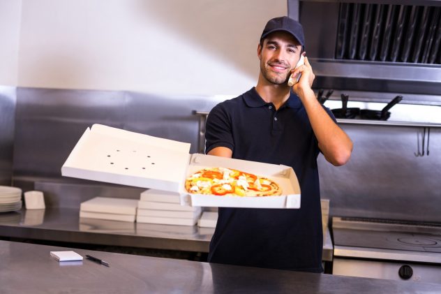 Pizza delivery man taking an order over the phone