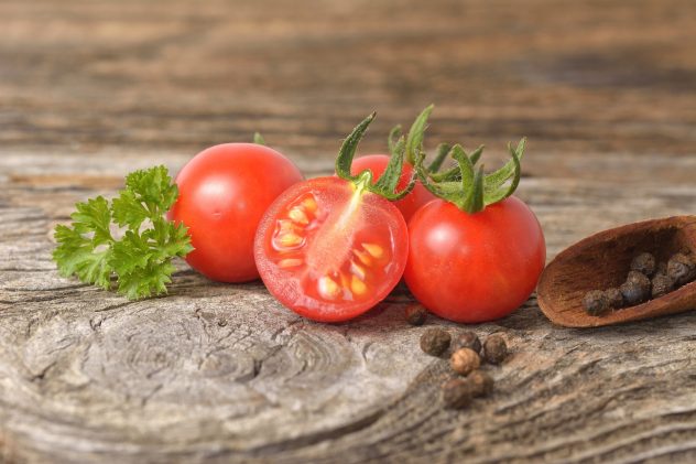 ripe tomatoes on wood background