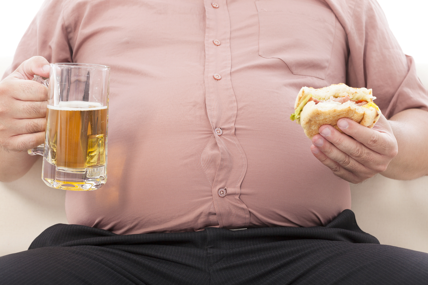 fat business man holding beer mug and hamburger