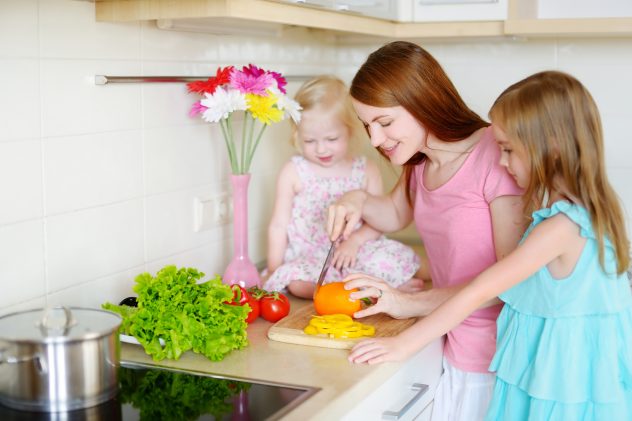 Mother and daughters cooking dinner