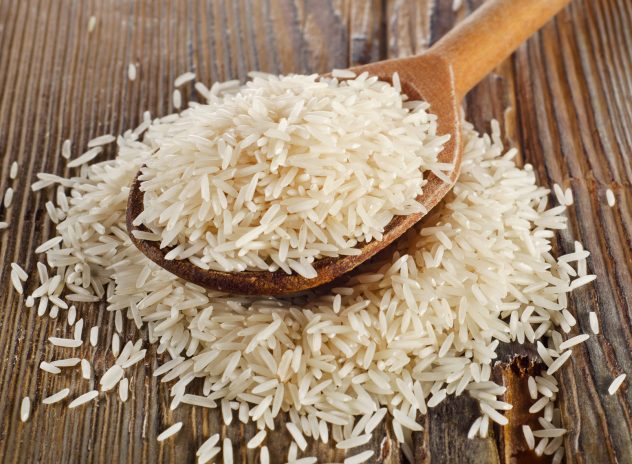 Raw basmati rice in wooden spoon